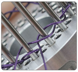 Wire being wrapped around jig pegs